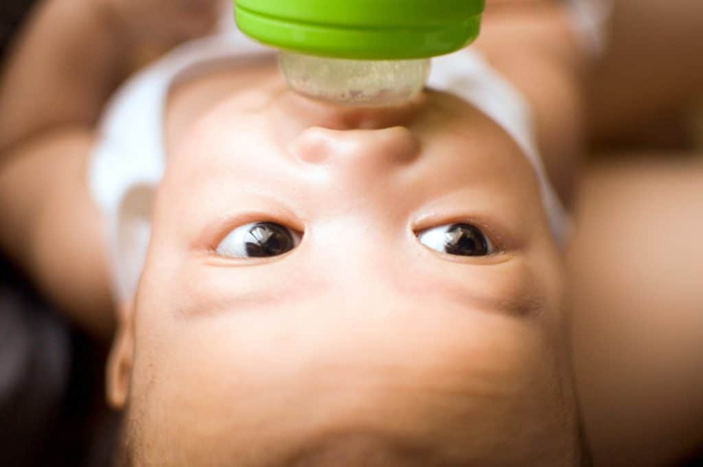 A baby is bottle feeding